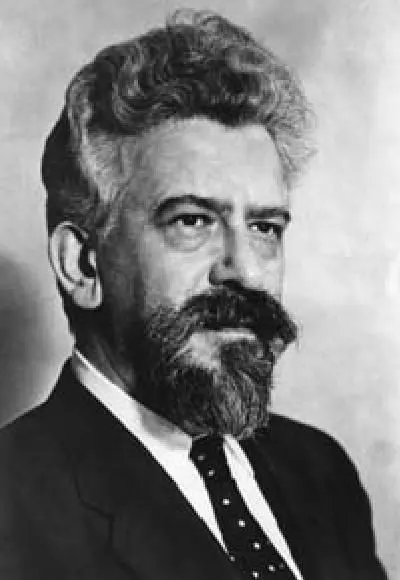 Rabbi Abraham Joshua Heschel photographed in a dark suit and tie.