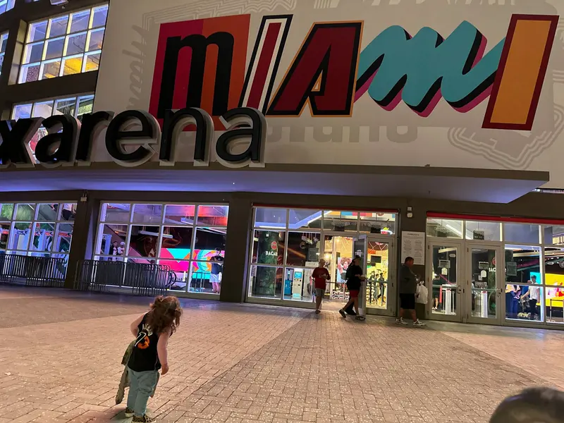One of AJ’s daughters in an Adebayo jersey outside Kaseya Center, under the arena’s giant MIAMI mural.